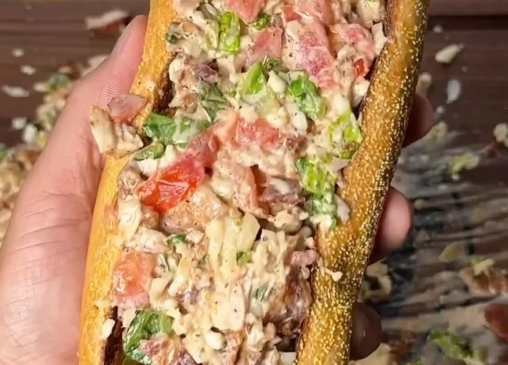 Chopped chicken bacon ranch sandwich with fresh ingredients and creamy dressing