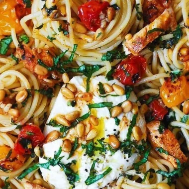 Dish of Lemon Butter Garlic Chicken Pasta with roasted cherry tomatoes and burrata cheese