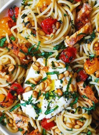 Dish of Lemon Butter Garlic Chicken Pasta with roasted cherry tomatoes and burrata cheese