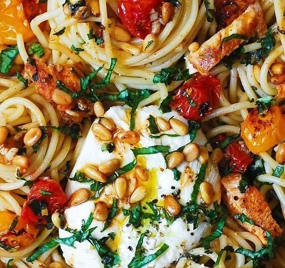 Dish of Lemon Butter Garlic Chicken Pasta with roasted cherry tomatoes and burrata cheese