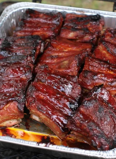 Succulent BBQ ribs on a grill with smoky flavor and delicious glaze.