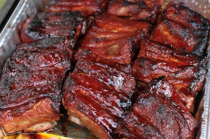 Succulent BBQ ribs on a grill with smoky flavor and delicious glaze.