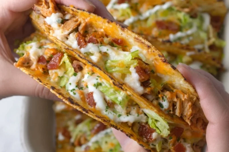 Delicious cheesy oven-crispy chicken bacon ranch tacos on a platter