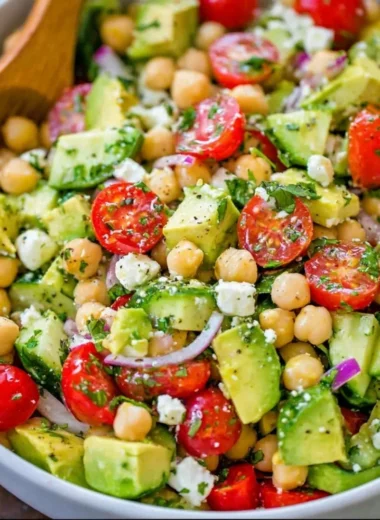 A colorful Chickpea Salad with fresh vegetables and herbs in a bowl.