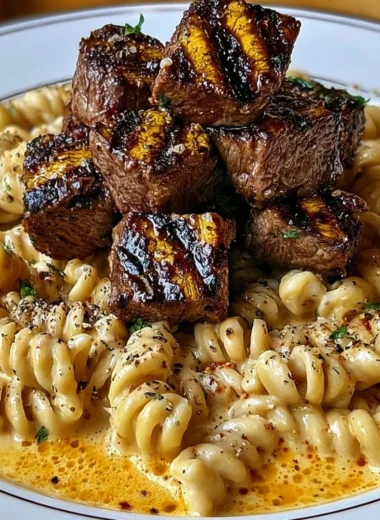 Creamy garlic butter steak bites served with spicy Cajun Alfredo twisted pasta