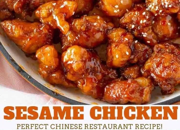 Plate of crispy sesame chicken garnished with sesame seeds and green onions