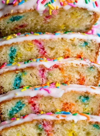 Sliced Funfetti Pound Cake topped with colorful sprinkles