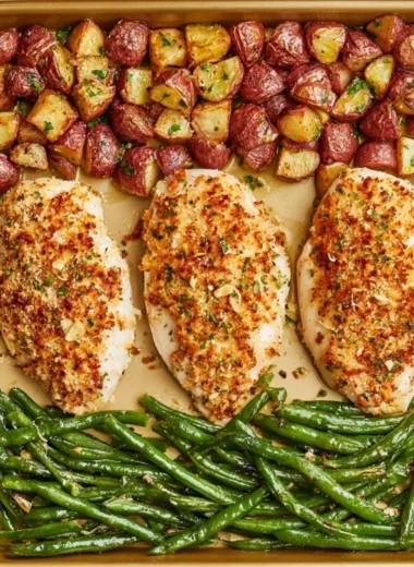 Parmesan Crusted Chicken on a sheet pan with colorful veggies