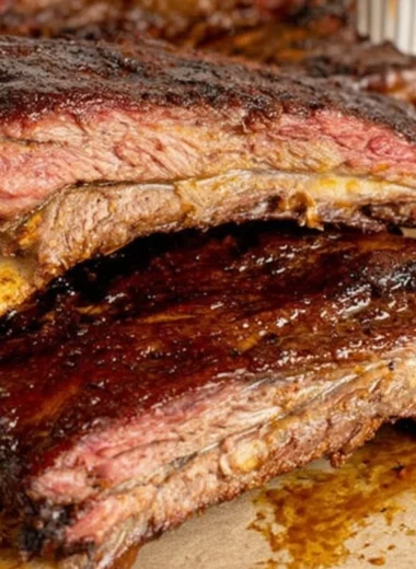 Smoky barbecue beef ribs cooked to perfection on the grill.