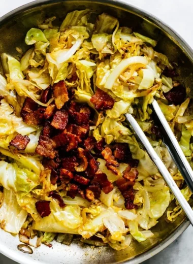 Plate of Southern Fried Cabbage garnished with spices and bacon