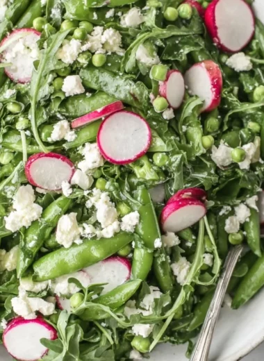 Vibrant sugar snap pea salad with fresh vegetables and dressing