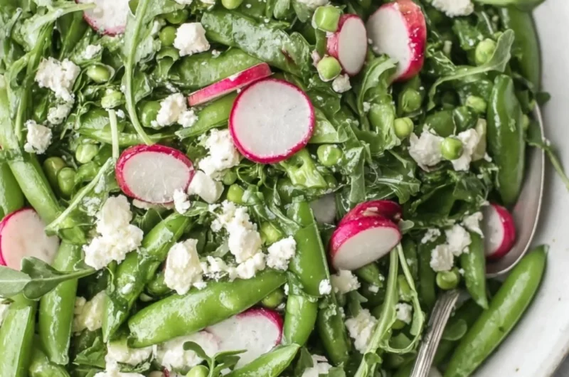 Vibrant sugar snap pea salad with fresh vegetables and dressing