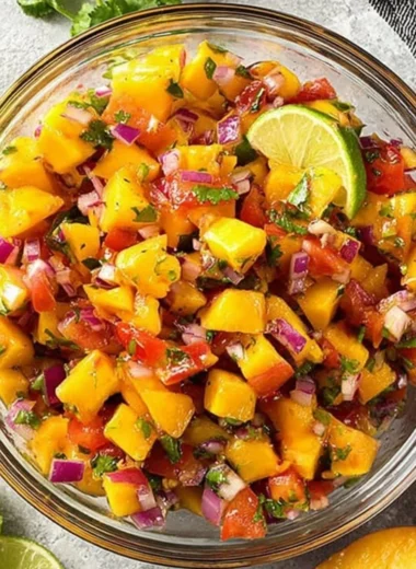 Bowl of sweet and spicy peach salsa with fresh ingredients.