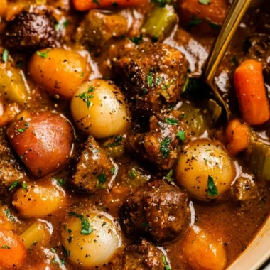 A hearty bowl of beef stew with tender pieces of meat and vegetables