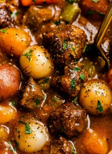 A hearty bowl of beef stew with tender pieces of meat and vegetables
