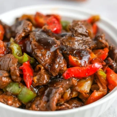 Delicious black pepper beef dish garnished with fresh herbs