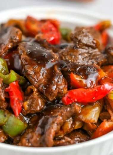Delicious black pepper beef dish garnished with fresh herbs