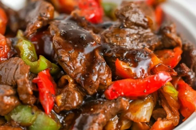 Delicious black pepper beef dish garnished with fresh herbs