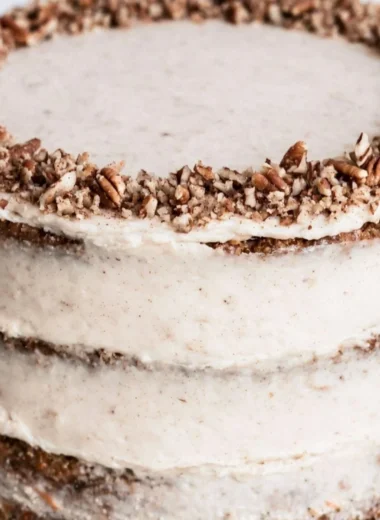 Delicious slice of brown butter carrot cake topped with cream cheese frosting