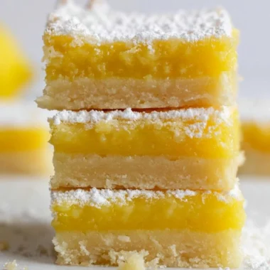 Delicious homemade lemon bars with a fluffy texture and zesty lemon topping