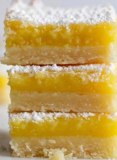 Delicious homemade lemon bars with a fluffy texture and zesty lemon topping