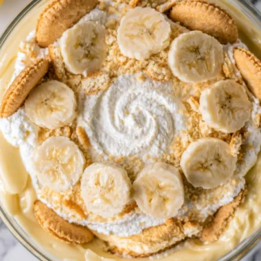 Creamy homemade banana pudding topped with whipped cream and banana slices