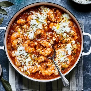 Cozy Prawn Saganaki served with cheese and herbs in a rustic dish