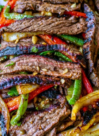 Delicious steak fajitas served with colorful peppers and onions
