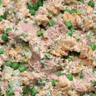 Cozy tuna pasta salad bowl with fresh ingredients and herbs