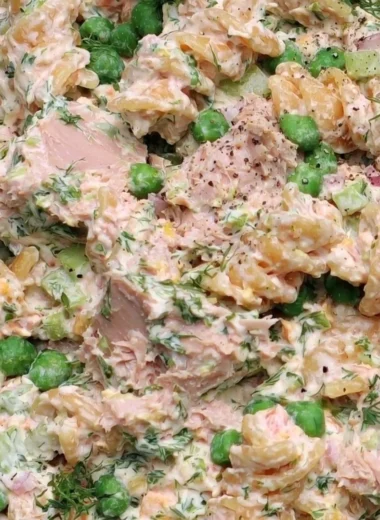 Cozy tuna pasta salad bowl with fresh ingredients and herbs