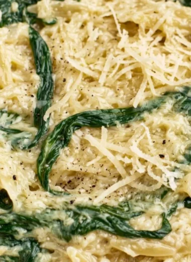 Creamy garlic spinach orzo dish garnished with herbs