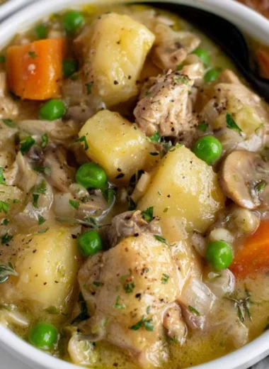 Bowl of easy slow cooker chicken stew with vegetables and herbs
