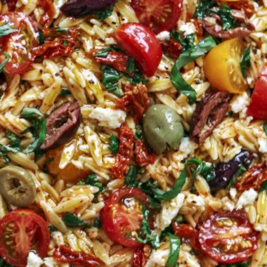 Delicious Greek Orzo salad with tomatoes, olives, basil, and feta cheese