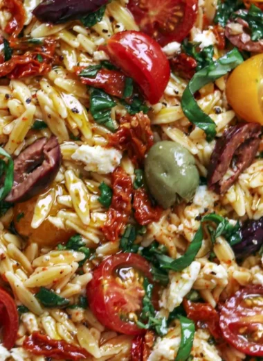 Delicious Greek Orzo salad with tomatoes, olives, basil, and feta cheese