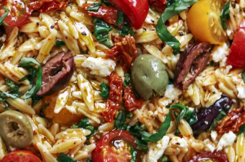 Delicious Greek Orzo salad with tomatoes, olives, basil, and feta cheese