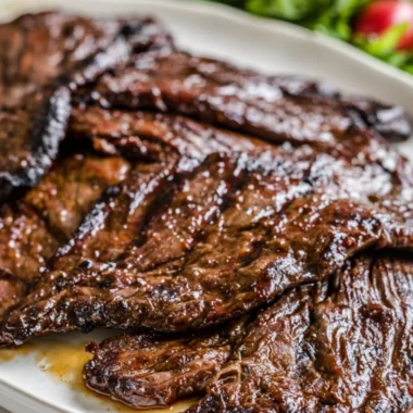 Grilled flank steak marinated in citrus, served with fresh herbs and vegetables.