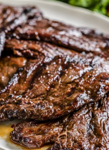 Grilled flank steak marinated in citrus, served with fresh herbs and vegetables.