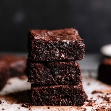 Delicious homemade brownies on a plate with chocolate drizzle