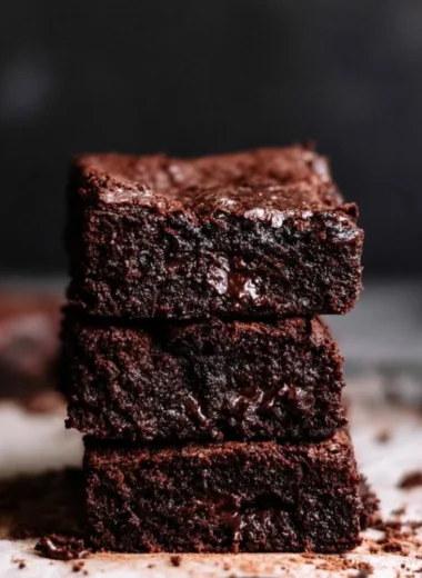 Delicious homemade brownies on a plate with chocolate drizzle