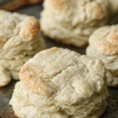Freshly baked homemade buttery biscuits on a plate