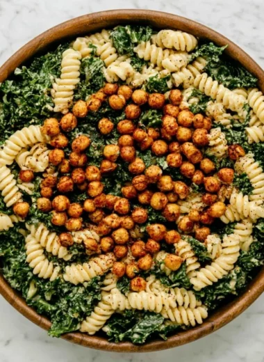 Delicious Kale Caesar Pasta Salad served in a bowl with fresh toppings.