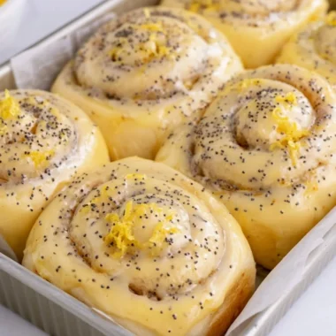 Freshly baked lemon rolls with a zesty glaze on a wooden table