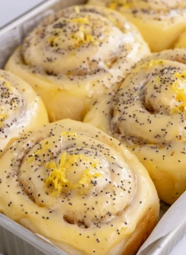 Freshly baked lemon rolls with a zesty glaze on a wooden table