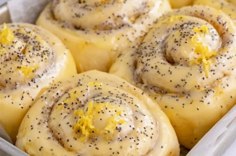 Freshly baked lemon rolls with a zesty glaze on a wooden table
