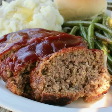 Juicy old fashioned meatloaf served with mashed potatoes and gravy