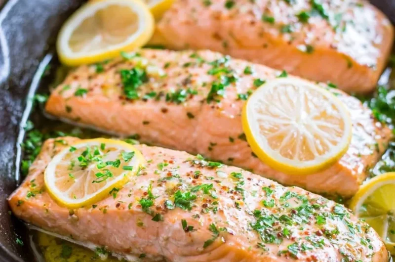 Delicious oven roasted salmon garnished with fresh herbs on a plate.
