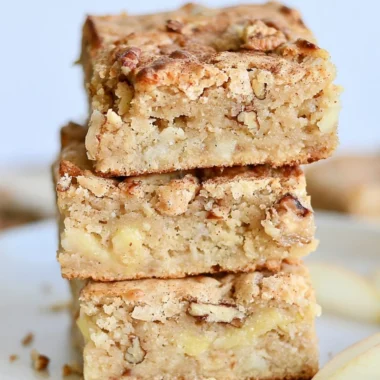 Delicious cozy apple brownies topped with nuts and drizzled chocolate