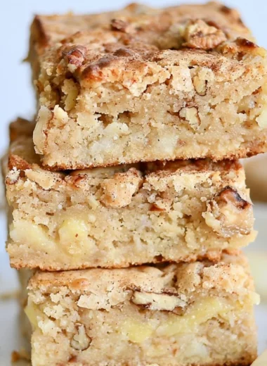 Delicious cozy apple brownies topped with nuts and drizzled chocolate
