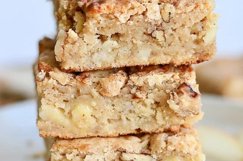 Delicious cozy apple brownies topped with nuts and drizzled chocolate