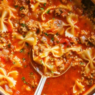 Delicious one-pot lasagna soup in a bowl, garnished with cheese and herbs
